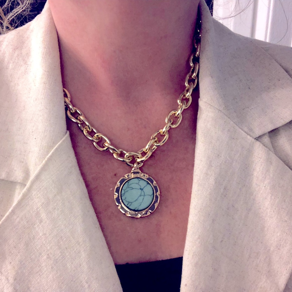 Trendy gold chain necklace with vibrant round blue pendant